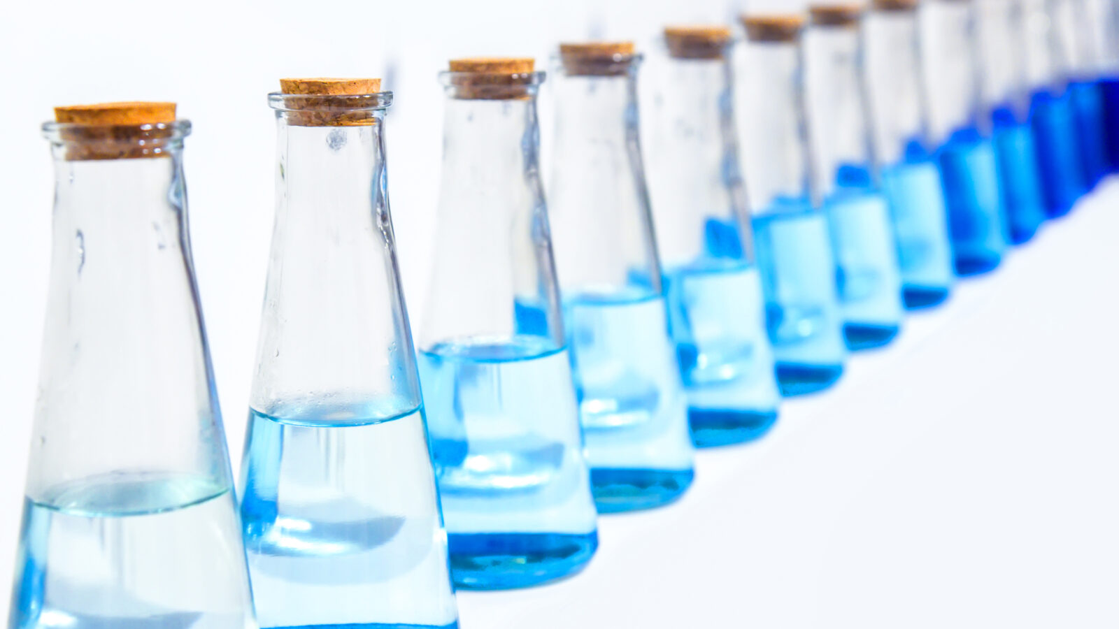 A glass bottle with blue liquid